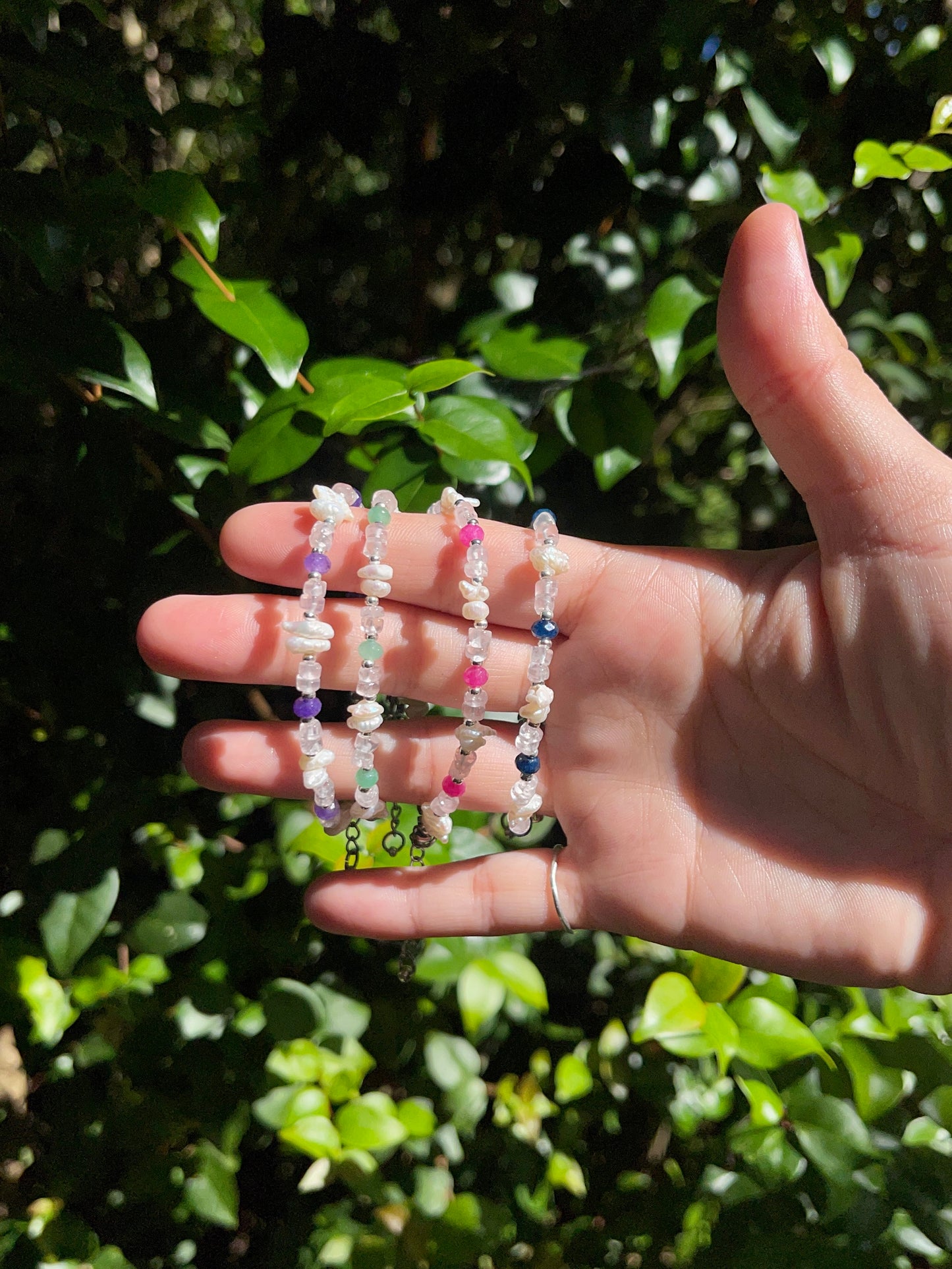 Blue stone, silver, and pearl Bracelet (left)